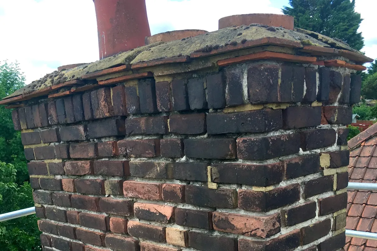 Damaged brick chimney stack prior to repair and rebuilding in Canterbury, Kent