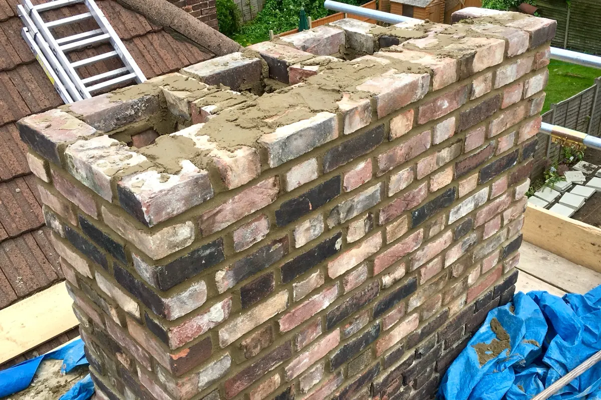 Chimney stack rebuilding in progress in Canterbury with new brickwork and mortar
